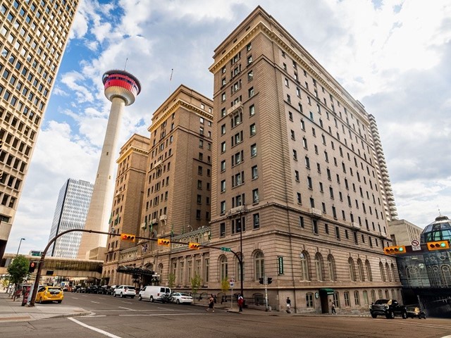 Exterior of the Fairmont Palliser Hotel beside the Calgary Tower