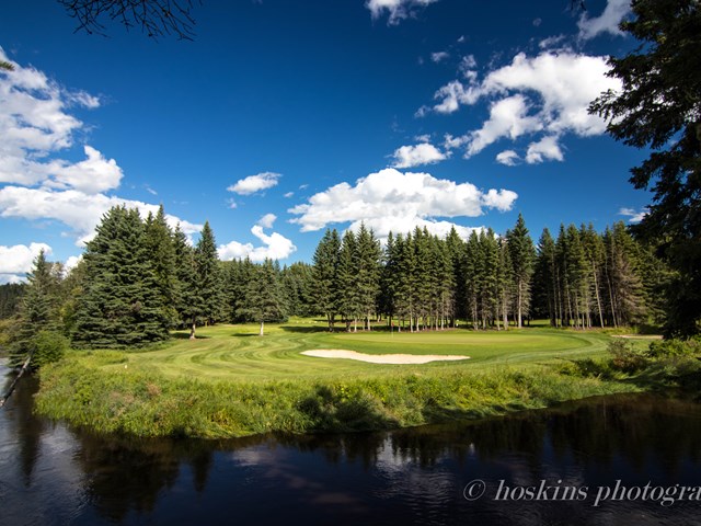 1st Green is a challenging shot across the river | ''