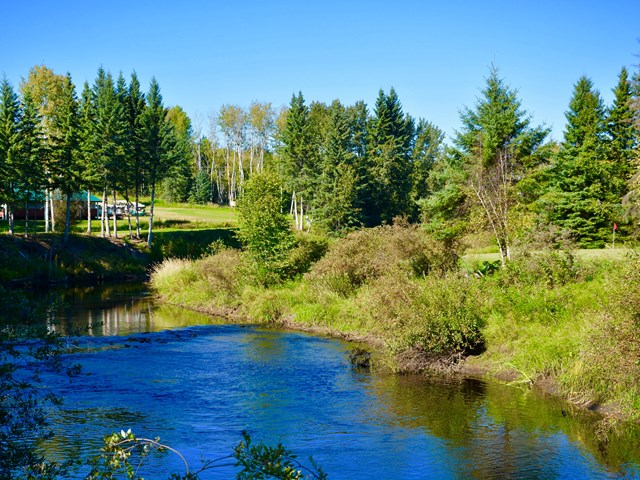 Clubhouse and 1st green from bridge | ''