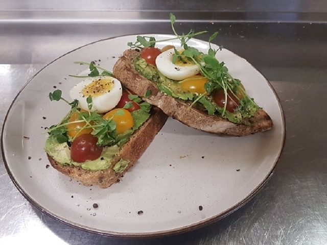 Sourdough bread with some avocado, heirloom cherry tomatoes, egg,house microgreens